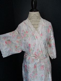 "Vintage Barbizon robe in white with pink, blue and green floral print and white lace. 40% Nylon 30% Cotton 30% Polyester. Size Large. Two pockets with tie on iniside and outside sash to keep it closed. 20.5\" underarm to underarm 11.5\" sleeve 51\" length" Spring Floral Print Fitted Robe, Fitted Floral Print Spring Robe, Fitted Floral Print Robe For Spring, Fitted Spring Daywear Robe, Fitted White Floral Print Sleepwear, Fitted Robe For Spring Daywear, White Lace Trim Robe For Summer, White Feminine Fitted Robe, Summer Robe With Lace Trim For Daywear