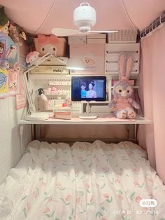 there is a small room with a bed and desk in the corner that has stuffed animals on it