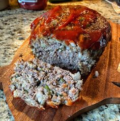 a meatloaf on a cutting board with a knife