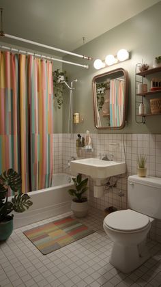 a bathroom with a toilet, sink and bathtub covered in colorful shower curtaines