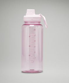 a pink plastic water bottle with a measuring cup on top