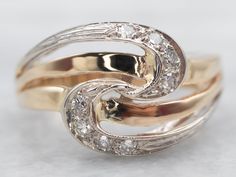 two gold rings with diamonds on them