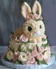 a cake decorated with flowers and an easter bunny