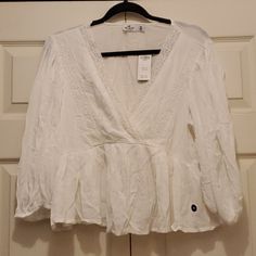 Brand New W Tags Hollister Brand White Cotton Peasant Style Top With Lace Detail. It Is Somewhat Cropped & Comes In A Medium Summer Peasant Tops With V-neck, Spring Peasant V-neck Top, Peasant V-neck Blouse For Brunch, Spring Peasant Style V-neck Top, Peasant V-neck Top For Vacation, White V-neck Peasant Top For Day Out, Peasant Style V-neck Top For Day Out, Outfit Organizer, White Peasant Top