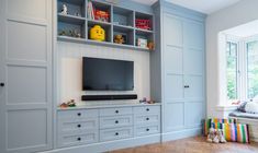 an entertainment center with built - in cabinets and a flat screen tv on the wall