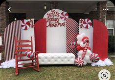 an outdoor christmas display with red and white decorations