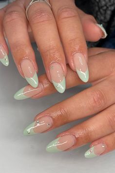 Step into elegance and indulge in our stunning collection of Soft Pink Stiletto Nails with Sage Green French and Delicate Rhinestone Accents. Discover these captivating nude-based beauties with an irresistible pop of sage green and dazzling rhinestone finishes. Click here to explore the full collection and elevate your style to new heights! 🌿✨ // Photo Credit: Instagram @setsby.lex Sage French Nails, Cute Sage Green Nails, Sage Green Nail Designs, Sage Green Nail, Sage Green Nails, Nails With Rhinestones, Green Acrylic Nails, Green French, Green Nail Designs