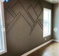 an empty room with wood floors and gray walls, painted in the same color scheme