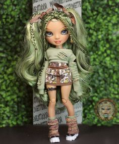 a doll with long green hair and boots