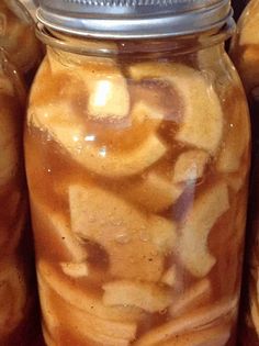 a jar filled with lots of food sitting on top of a shelf next to other jars