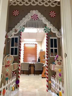 an entrance to a home decorated with gingerbreads and candy canes for christmas