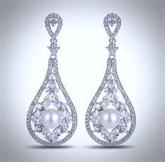 Lightweight and elegant, this beautiful pair of earrings will add glamour to any wedding dress or formal ensemble. Featuring 8mm pearls in an iridescent white color accented by sparkling cubic zirconia, the earrings are rhodium plated for a flawless finish. Overall length of the earring is 2" (approx. 5cm). Hypoallergenic - lead, nickel and cadmium free. White Pearl Bridal Earrings With Diamond Accents, White Pearl Earrings With Diamond Accents For Wedding, Glamorous White Bridal Earrings With Diamond Accents, Pearl Bridal Earrings With Diamond Accents For Wedding, Bridal Pearl Earrings With Diamond Accents For Wedding, Formal Diamond White Crystal Pearl Earrings, Silver Pearl Diamond Earrings For Wedding, White Cubic Zirconia Bridal Earrings For Pierced Ears, Formal White Cubic Zirconia Chandelier Earrings