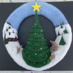 a felt christmas tree wreath with animals around it