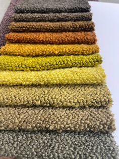 several colors of towels stacked on top of each other