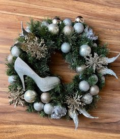 a christmas wreath with silver and silver ornaments on the front, and a pair of high heeled shoes