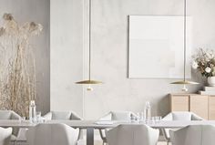 a dining room with white chairs and tables