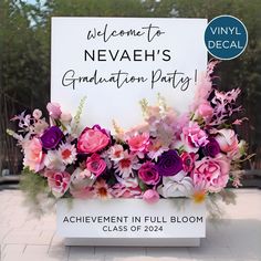 a sign that says welcome to neveah's graduation party with flowers on it