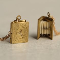 This personalised locket necklace is a miniature book made from solid brass which has darkened over time to a rich gold colour. Inside every locket is a secret hidden message, specially folded and fitted inside the locket to look just like the pages of a real book! If you like, we can also engrave the front cover.  The locket is a tiny, delicate size, measuring just 16mm x 10mm (about the size of a fingernail). The necklace chain is available in a variety of lengths. Please refer to our illustra Book Locket Necklace, Engraved Locket, Silk Purse, Personalized Book, Book Locket, Gold Engraving, Secret Messages, Proposal Gifts, Bookish Gifts