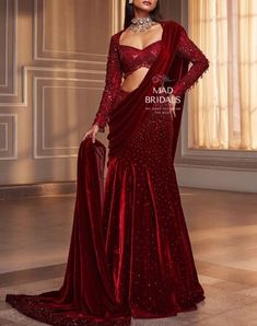 Get ready to dazzle in our Red Velvet Saree! It comes with a Hadwork blouse featuring trendy tassel detailing. The best part is It's a pre-stitched saree, and we've got you covered with stitched blouse pieces. You can choose any color and make any changes you like. Elevate your style effortlessly - click 'Buy Now' and make this stunning outfit yours today! Unveiling the Details: Color: Maroon Craftsmanship: Handwork Fabric: Pure Velvet **Important Notes All our items are meticulously handmade and uniquely tailored for our valued customers. Expect minor variations in the actual product compared to the displayed image. Product color may slightly vary due to photographic lighting sources or your monitor settings. Please be advised that once an order is placed, it cannot be canceled, and no ex Burgundy Saree, Manish Malhotra Bridal, Lehenga Sari, Baju Kahwin, Velvet Saree, Indian Fashion Trends, Saree Designer, Fancy Sarees Party Wear, Traditional Indian Dress