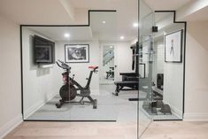 a home gym with exercise equipment and mirrors