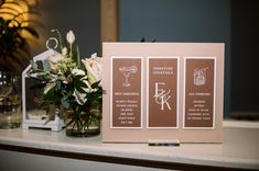 the table is set up with flowers and cards for guests to write their names on