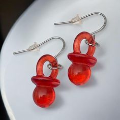 Bring fun and nostalgia to your jewelry collection with our pacifier earrings in bright red. Equipped with hypoallergenic stainless steel ear hooks, these 3.5 cm long earrings are very comfortable to wear and are ideal for sensitive ears. These fun pieces of jewelry are a real eye-catcher and are perfect for gender reveal parties, 90s themed parties or simply as an eye-catching accessory. Let yourself be convinced by their original touch and their excellent compatibility. Trendy Red Earrings For Birthday, Playful Red Drop Earrings, Playful Personalized Red Jewelry, Playful Nickel-free Red Earrings, Playful Red Dangle Jewelry, Playful Red Earrings For Pierced Ears, Playful Red Pierced Earrings, Playful Red Jewelry For Birthday, Playful Red Hypoallergenic Jewelry