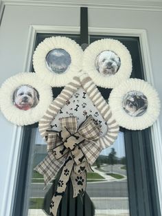 a dog's paw print wreath is hanging on the front door