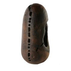 an old wooden mask with holes in the middle on a white background for use as a decoration