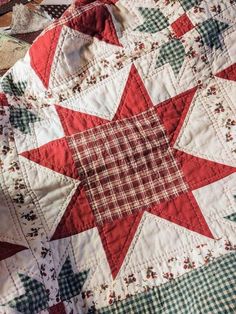 a red and white quilt on top of a bed