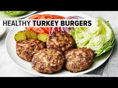 healthy turkey burgers on a plate with lettuce and tomatoes