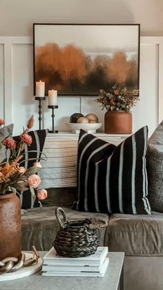 a living room filled with lots of furniture and flowers on top of a coffee table