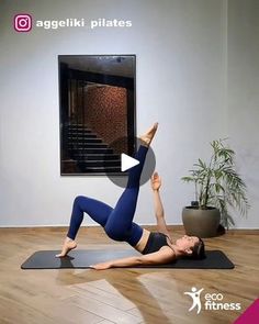 a woman is doing yoga in front of a wall with the words aggeliki pilates on it