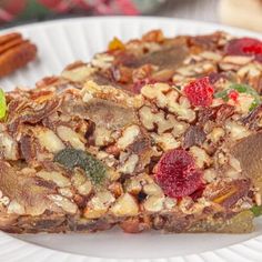 two pieces of fruit and nut bars on a white plate