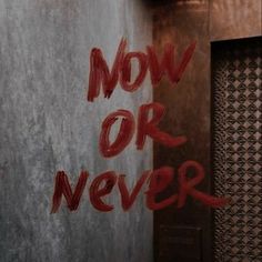 the words now or never are spray painted on a wall