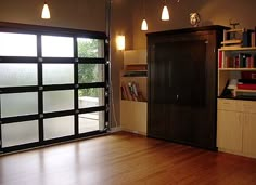 an empty living room with wood floors and sliding glass doors