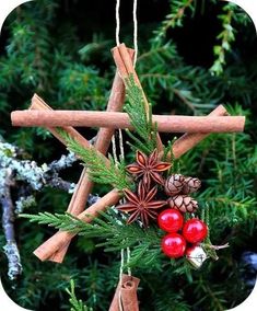 an ornament made out of cinnamon sticks and christmas decorations hanging from a tree