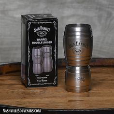 a wooden barrel sitting on top of a table next to a cardboard box with the label jack daniels