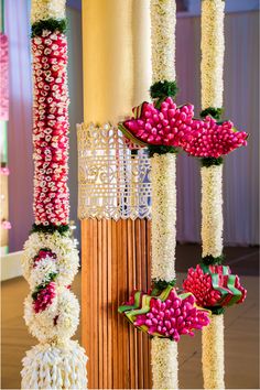 an arrangement of flowers are hanging from the ceiling