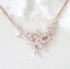 Our floral LILY rose gold cubic zirconia bridal necklace will add an elegant touch to any bridal look.  - Handcrafted with Swarovski Pure Brilliance CZ components. - All clear stones - Rhodium, yellow gold or rose gold finish - Necklace measures 16 inches and extends to 18 inches - Nickel free and hypoallergenic Delicate Rose Gold Cubic Zirconia Bridal Necklace, Wedding Jewelry With Cubic Zirconia Flower Pendant, Delicate Rose Gold Diamond Necklace For Wedding, Delicate Rose Gold Cubic Zirconia Necklace, Dazzling Rose Gold Diamond Necklace For Weddings, Rose Gold Wedding Necklace With Diamond Accents, Rose Gold Wedding Necklaces With Diamond Accents, Rose Gold Diamond Accent Wedding Necklace, Wedding Rose Gold Necklace With Diamond Accents