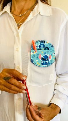 a woman holding a toothbrush in her pocket with an elephant patch on the pocket