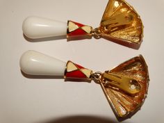 "The red and white enameled metal and plastic /Lucite dangling tier shape bottom size is 3 1/4\" inch tall x 1 3/4\" inch wide, 44.6 grams in weight in excellent vintage condition." White Enamel Clip-on Jewelry, Red Enamel Dangle Earrings, Unique Red Enamel Earrings, Red Enamel Clip-on Jewelry, Red Enamel Clip-on Earrings, Vintage Multicolor Enamel Earrings, Red Enamel Vintage Earrings, Vintage Enamel Clip-on Earrings For Evening, Swan Logo