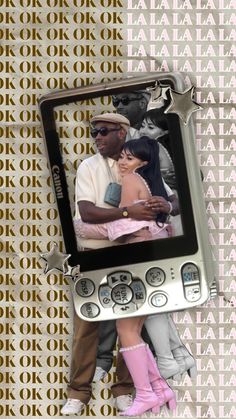 an old cell phone with a couple kissing on it's screen and the words kodak above it