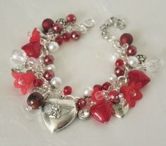 "Red Heart Charm Bracelet This beautiful bracelet has glass pearl beads, red glass beads, silver plated bead caps, lucite flower beads, sterling silver plated chain and pewter silver charms. 7\" long can be adjusted to 9\". Silver plated lobster clasp." Elegant Metal Beaded Bracelets For Valentine's Day, Beaded Jewelry For Anniversary On Valentine's Day, Vintage Red Bracelets For Anniversary, Elegant Beaded Bracelets With Charms For Valentine's Day, Red Costume Jewelry Bracelets As Gift, Valentine's Day Anniversary Beaded Jewelry, Valentine's Day Beaded Metal Jewelry, Vintage Bracelets With Heart Beads For Gift, Vintage Beaded Charm Bracelet As Gift