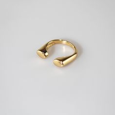 U-Shaped Signet Ring has a smooth, polished finish and a delicate, curved band. Its open design utters modern chic, while the two small, rounded ends add a touch of sophistication. Perfect for everyday wear or special occasions. 18k gold plated Stainless steel base Waterproof and tarnish free Available in US size 6-8 Ring sizing chart Formal Midi Rings With Simple Design, Formal Simple Design Open Midi Rings, Modern Open Band Midi Rings With Polished Finish, Classic Open Ring Midi Rings For Formal Occasions, Modern Polished Finish Open Band Midi Rings, Minimalist Open Midi Rings With Polished Finish, Minimalist Polished Open Midi Ring, Classic Bypass Ring With Polished Finish And Open Band, Classic Bypass Ring With Polished Finish