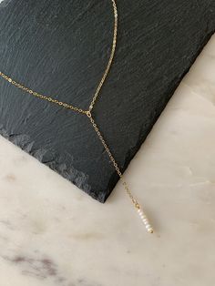 "This Y necklace is carefully handcrafted with a tiny pearl bar pendant drop. It comes in  14k gold filled or sterling silver finish. The necklace comes with an extender and is adjustable up to 2\". M A T E R I A L S * & * S I Z E *Necklace is adjustable  *Chain is 14k gold filled or sterling silver  *Bar Drop is 1\" *Y Drop is 3.5\"  How To Order: 1. Select your material. 2. Select your size; choose from: 12\"-14\" 14\"-16\" 16\"-18\" 18\"-20\" P R O D U C T I O N * T I M E S All items in my sh Modern Minimal Jewelry, Pearl Drop Necklace, Chic Bracelet, Y Necklace, Jewelry Simple, Silver Bar, Minimal Jewelry, Bar Pendant, Layering Necklace