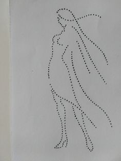 a piece of white paper with black dots on it and a drawing of a woman's head