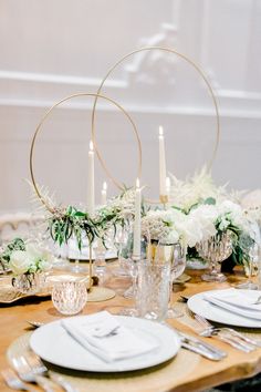 the table is set with white flowers and candles