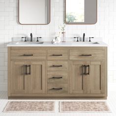 a bathroom vanity with two mirrors above it