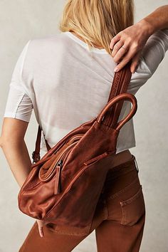 Designed to be slung over your shoulder or styled as a backpack, this soft leather sling bag from our We The Free collection features zippered details and defined top handles for added classic shape. * Lined interior * Zipper top closure * Adjustable belted strap | We The Free Soho Convertible Sling Bag at Free People in Brown Free People Soho Convertible Sling, Casual Sling Bag Women, Crossbody Sling Bag For Women, Leather Sling Bags Women, Enby Style, Fall Purses, 2023 Birthday, Sling Bags Women, Leather Sling Bags