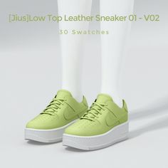 a pair of green sneakers with white soles